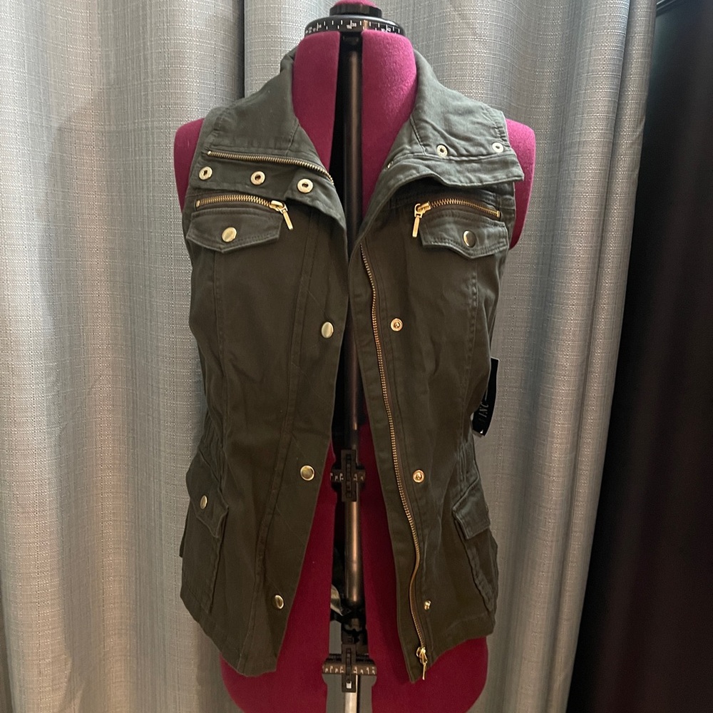 New with tags! I-N-C Moto vest with gold tone hardware. Size medium.